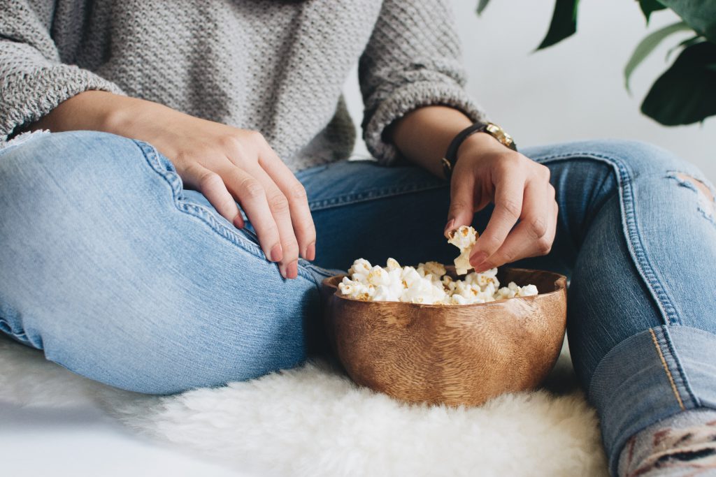 Woman with popcorn bowl